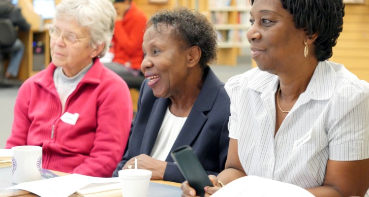 Three women sitting at a table at a Shared Reading group