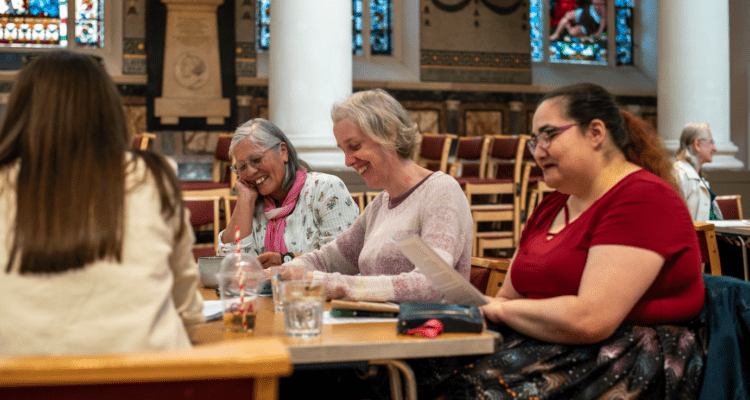 Three women laughing in a Shared Reading group