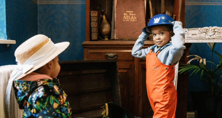 Two children in the Heritage Space dressing up