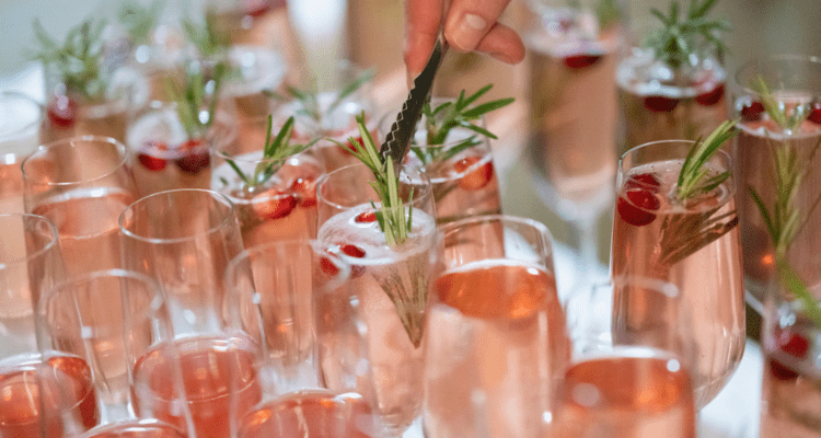 Champagne flutes with rosemary and berries