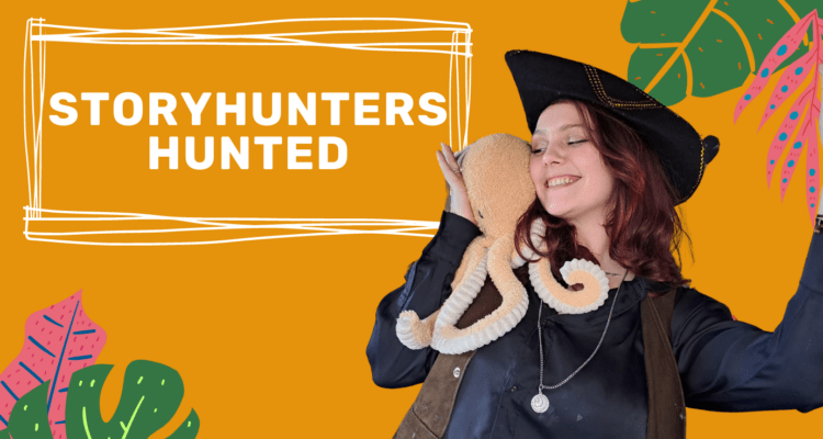 Storyhunter Jelly Belly cuddling an octopus teddy and wearing a pirate hat smiling